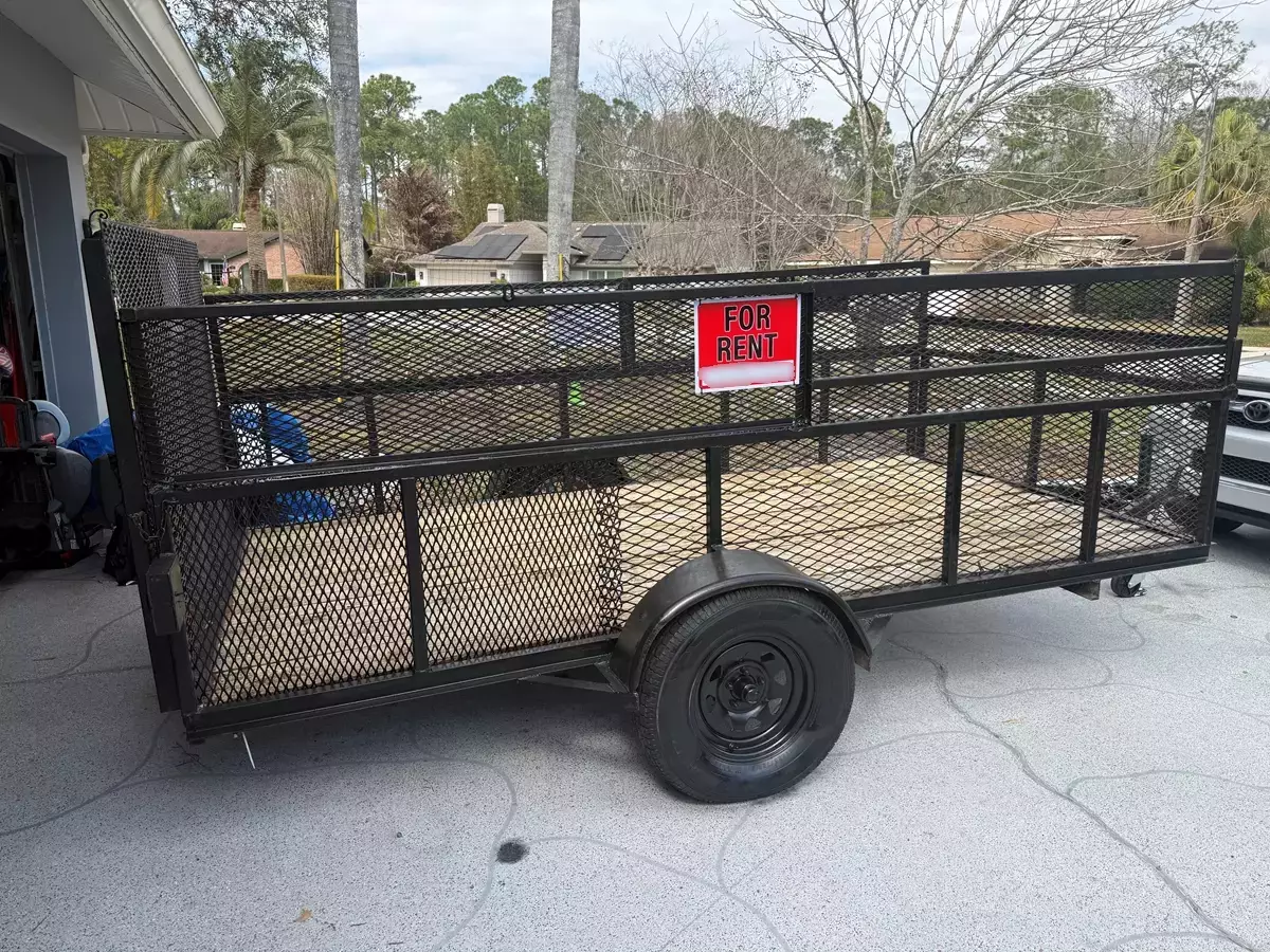 Reliable 6' x 12' Utility Trailer with mesh sides and drop down